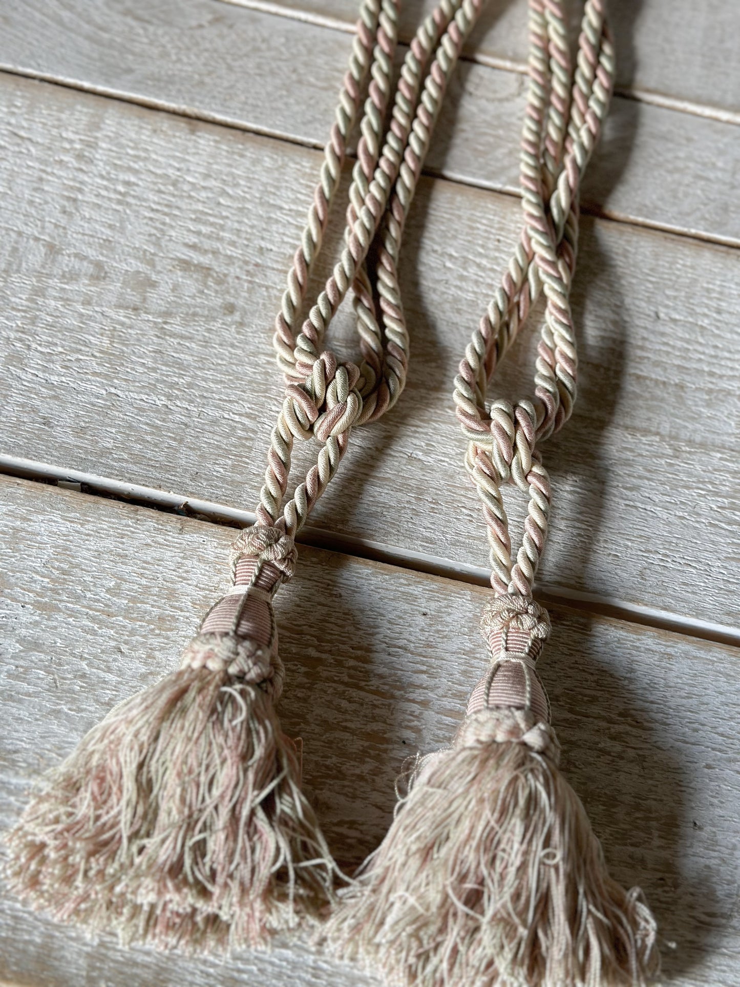 A pair of pretty vintage pastel pink, sage green and ivory curtain tie backs