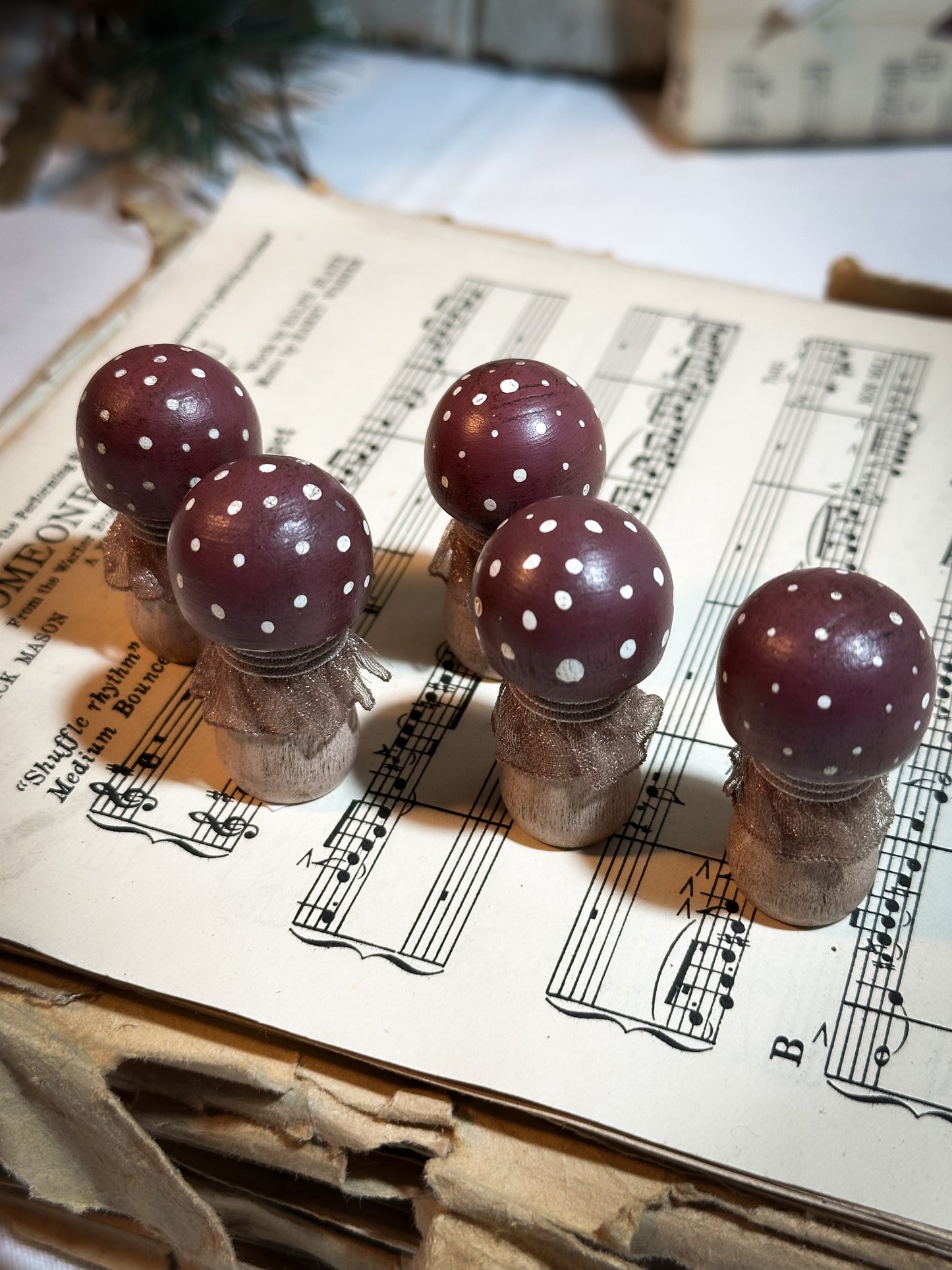 A wooden hand painted and trimmed Christmas village toadstool