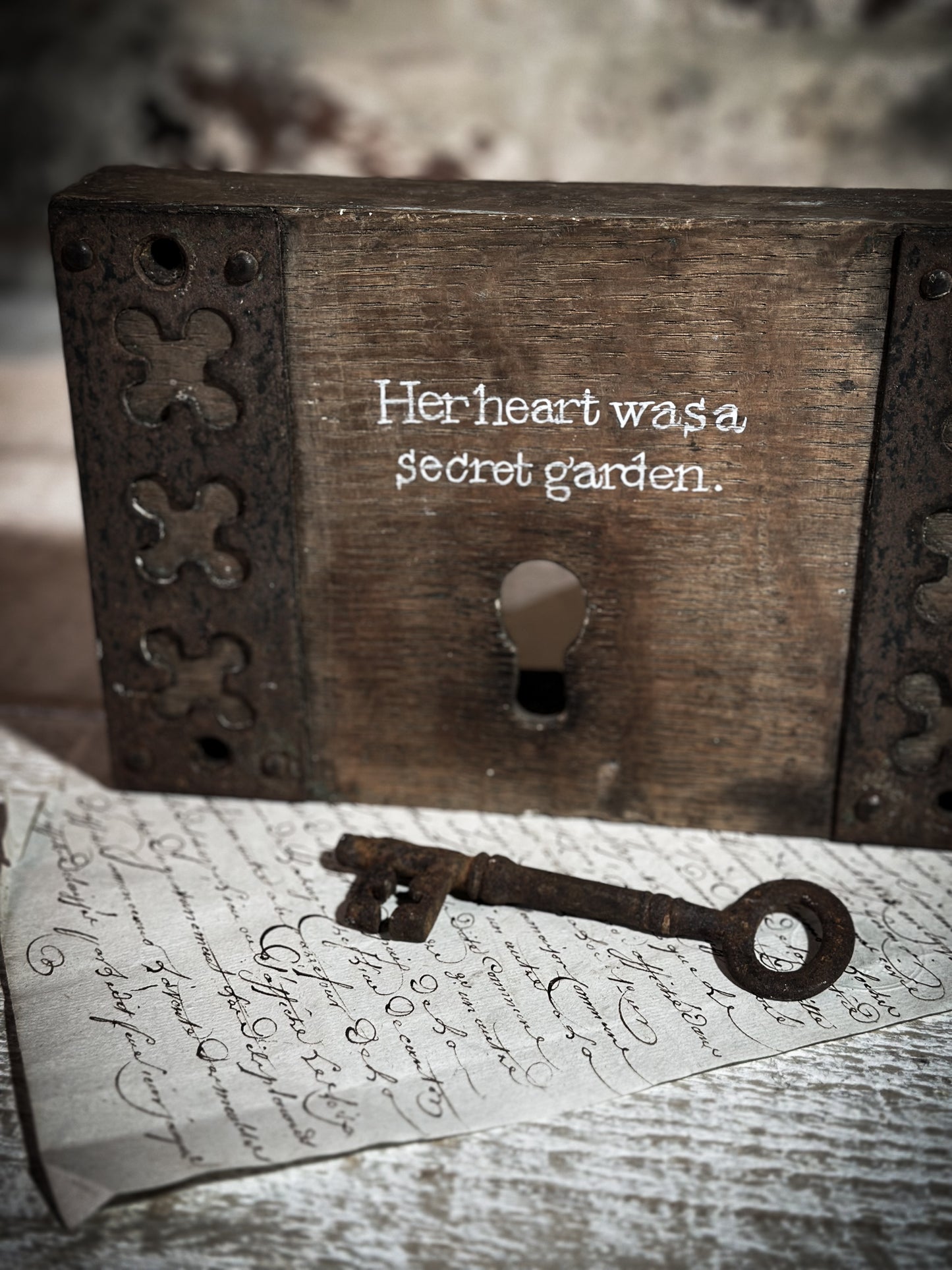 A salvaged original door lock with a painted quote