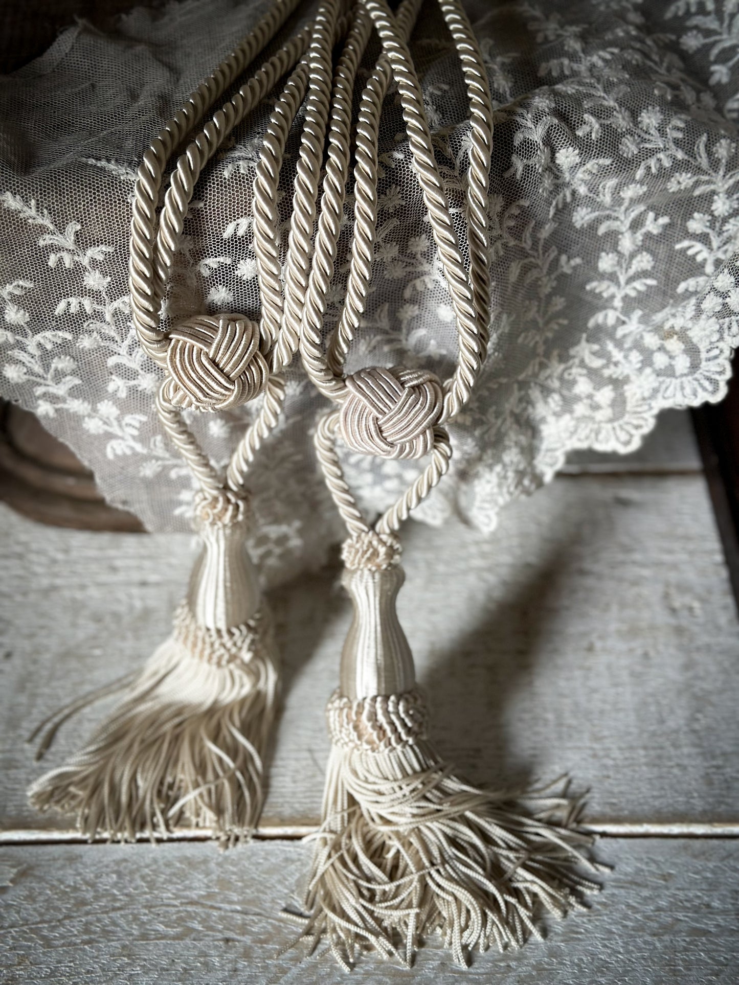 A pair of pretty vintage ivory curtain tie backs