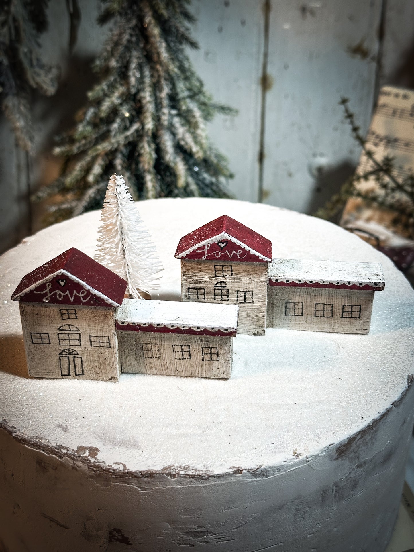 A pretty vintage German Erzgebirge Putz wooden village house painted with a Christmas quote