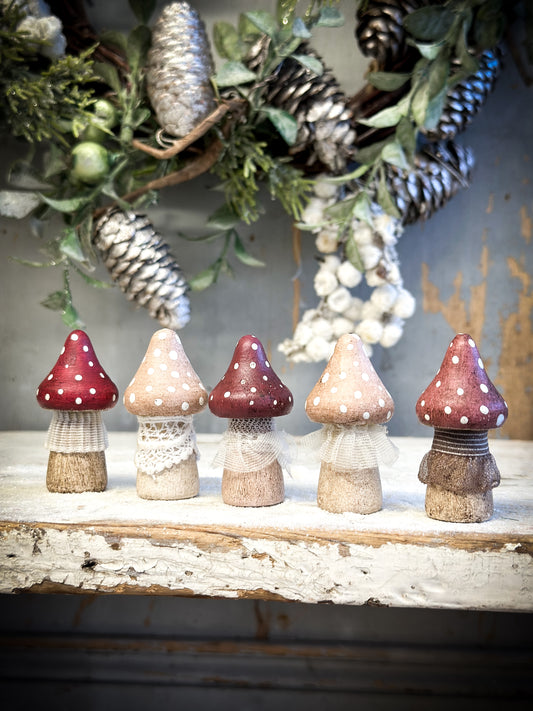 A wooden hand painted and trimmed Christmas village toadstool medium pointy one