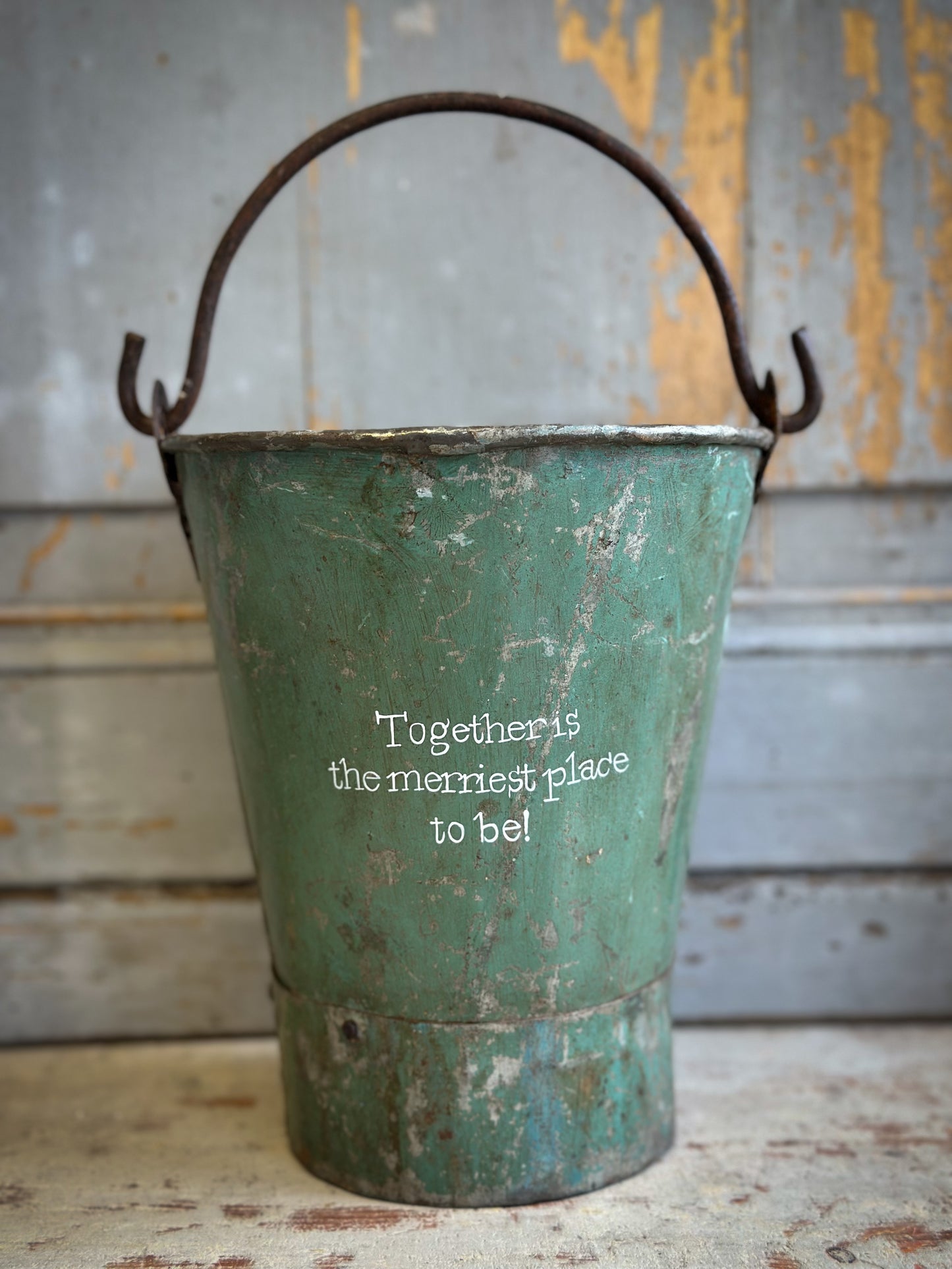 A Recycled Metal Mini Christmas Tree Bucket With A Hand Painted Quote