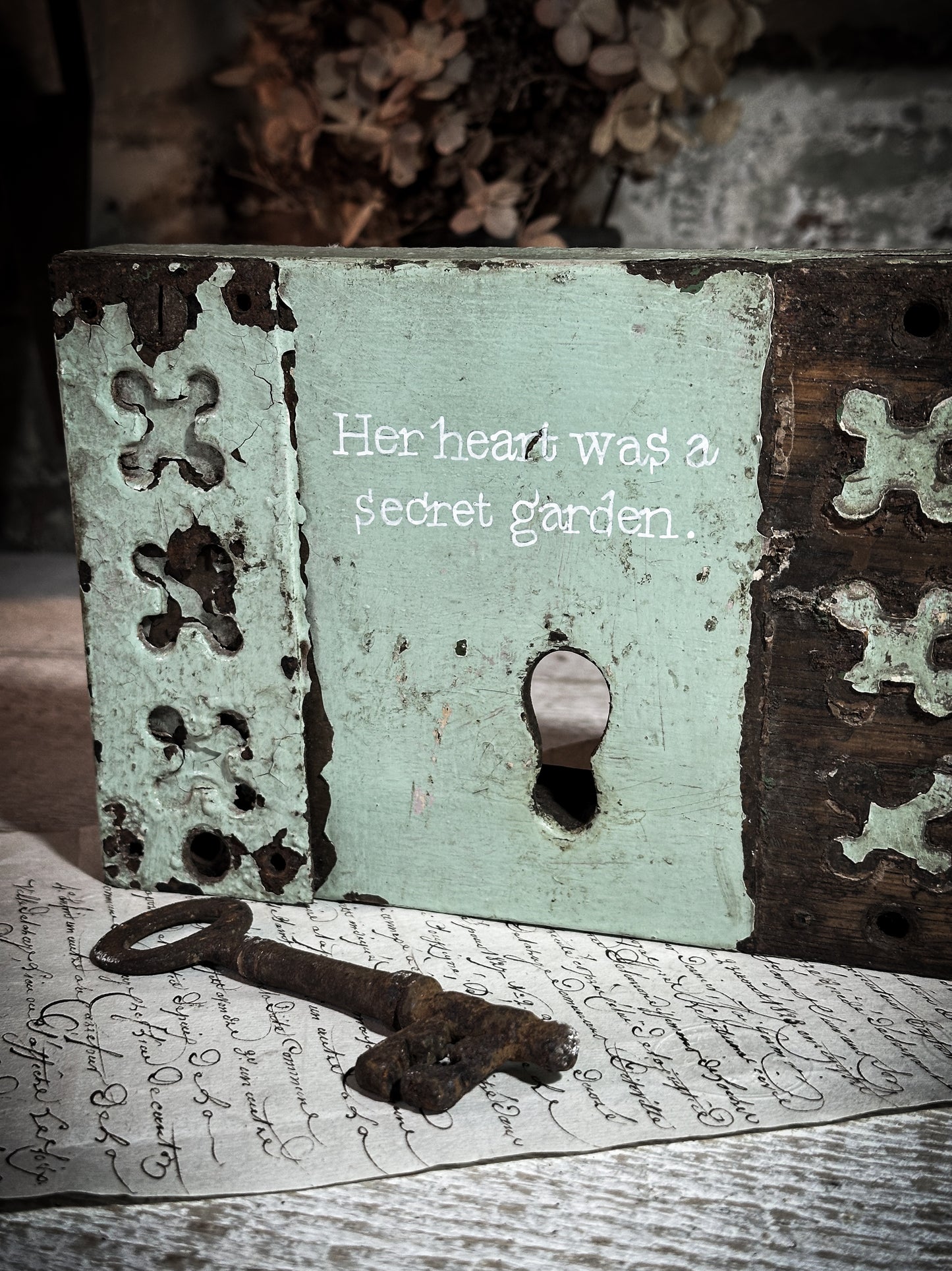 A salvaged original door lock with a painted quote