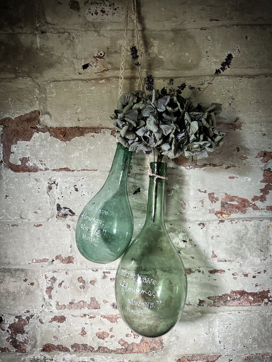 A beautiful antique hanging bulb bottle with a hand painted quote