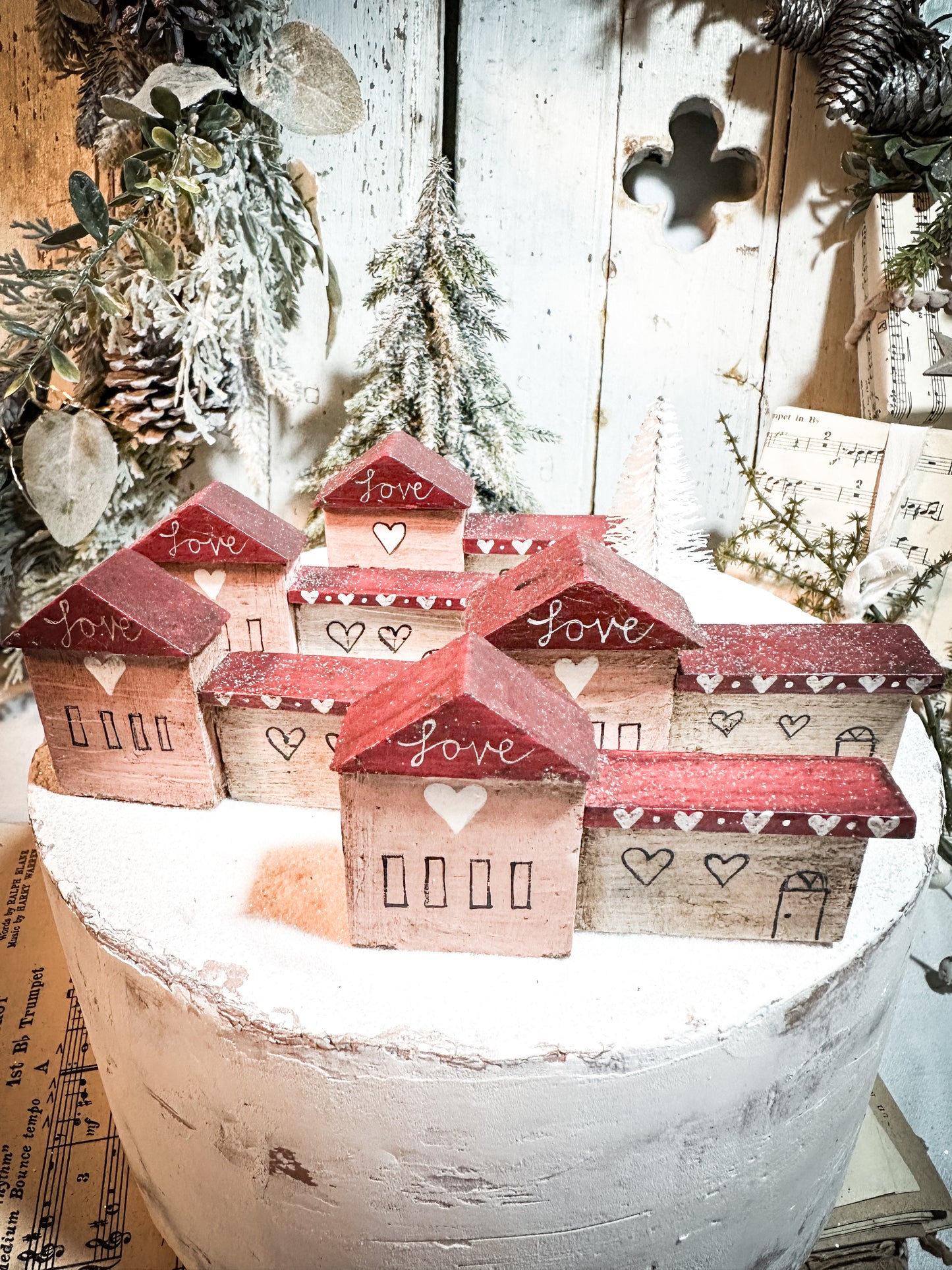 A pretty vintage German Erzgebirge Putz wooden village house painted with a Christmas quote