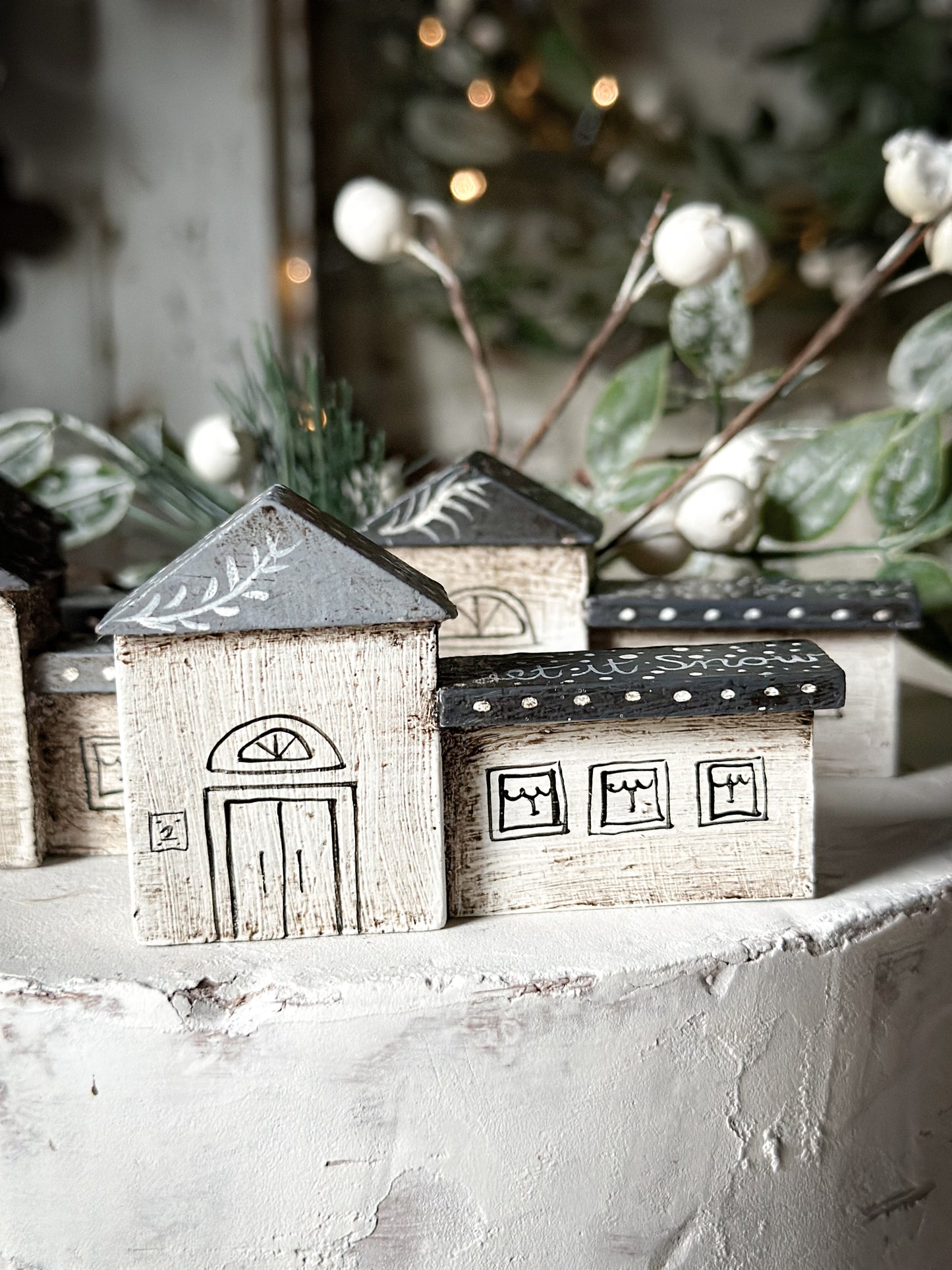 A pretty vintage German Erzgebirge Putz wooden village house painted with a Christmas quote