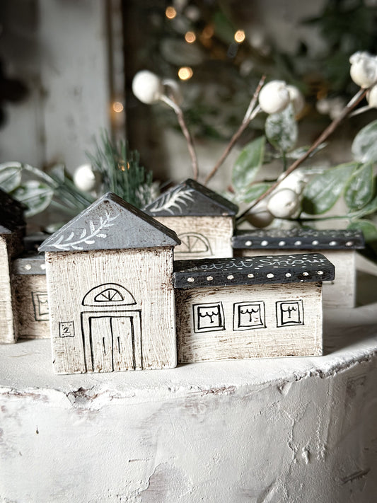 A pretty vintage German Erzgebirge Putz wooden village house painted with a Christmas quote