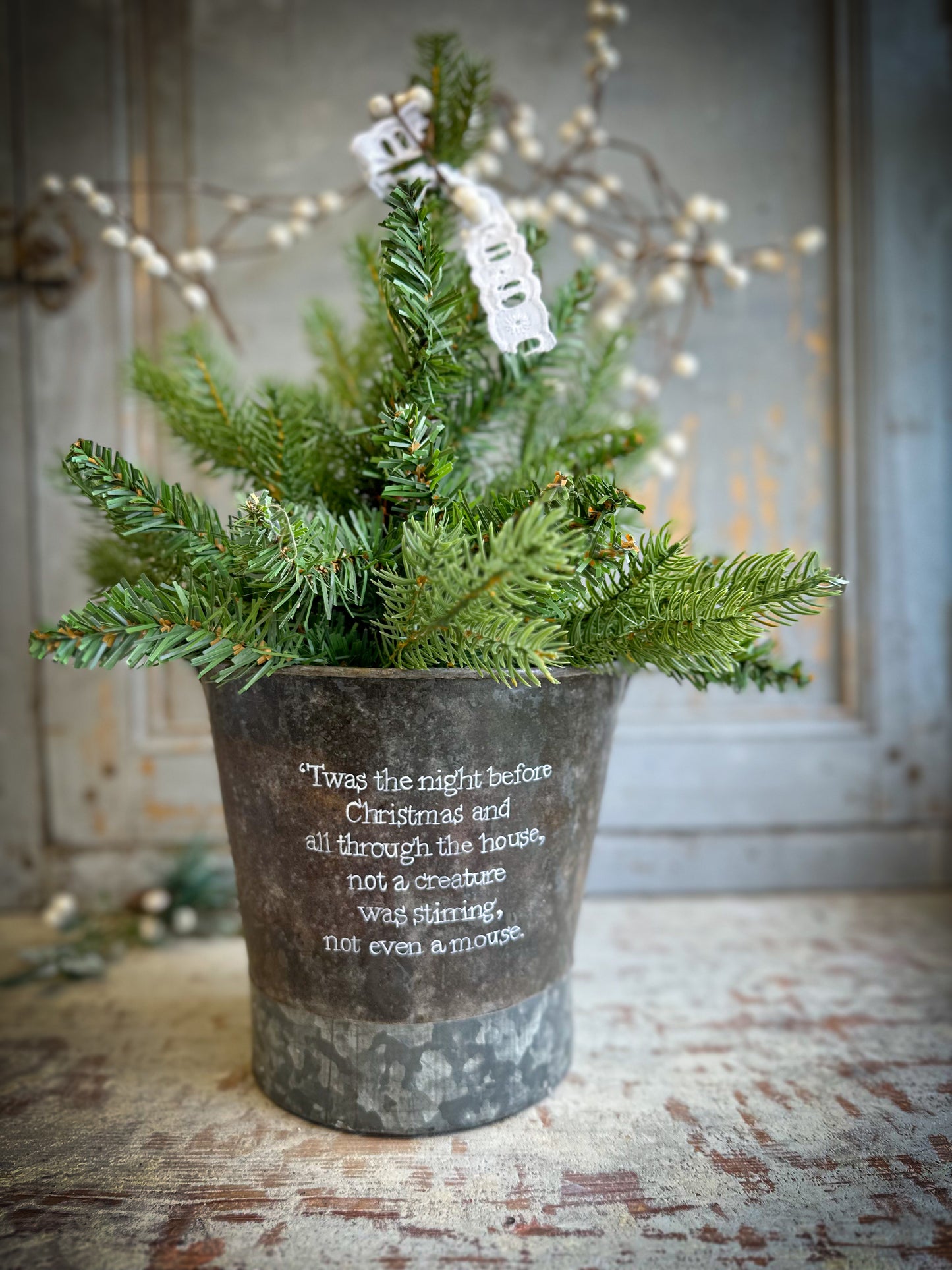 A Recycled Metal Small Christmas Tree Bucket With A Hand Painted Quote