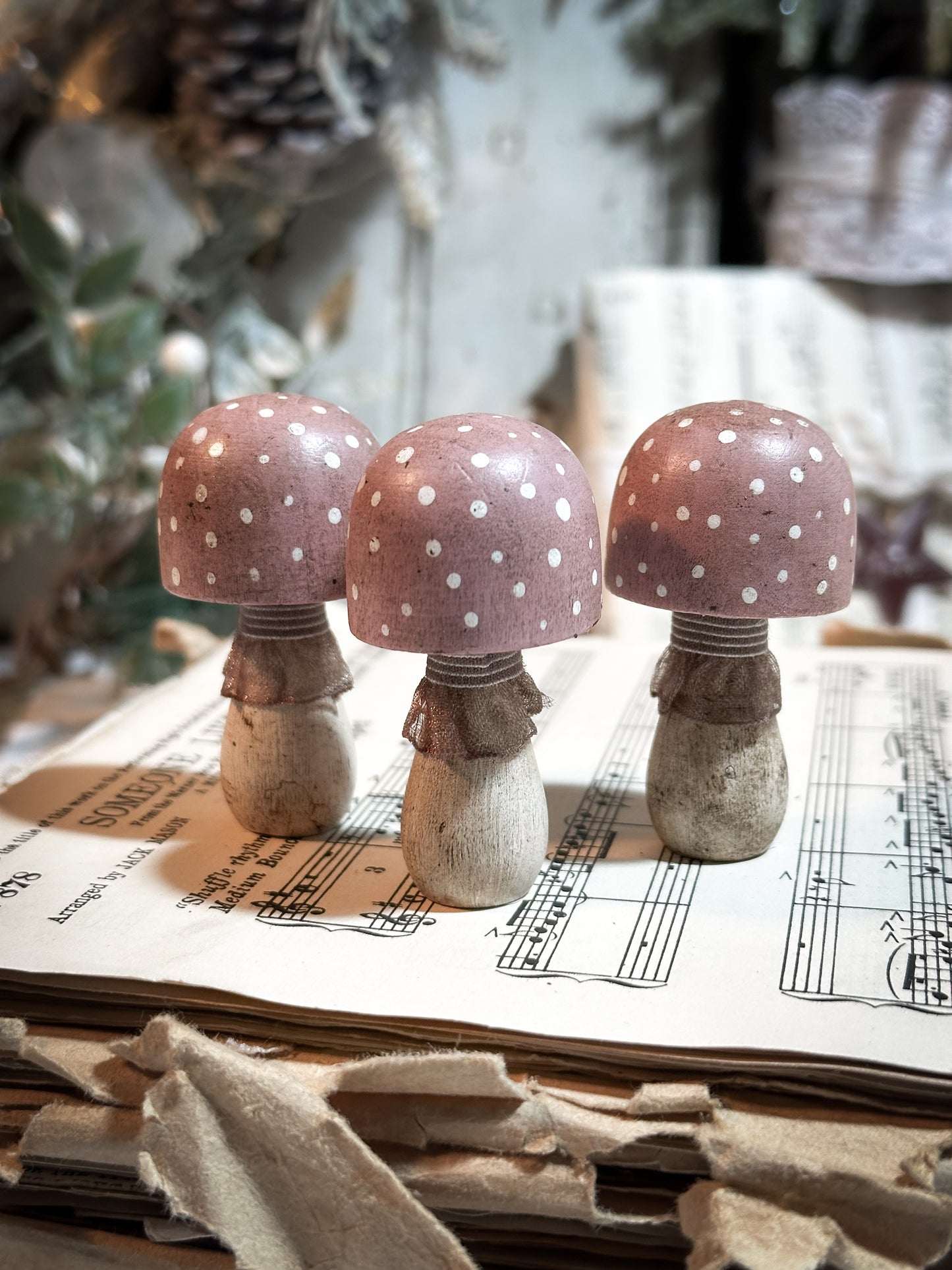 A wooden hand painted and trimmed Christmas village toadstool