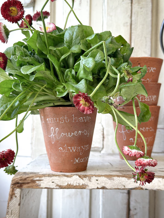 A Victorian terracotta pot with a quote “I must have flowers”