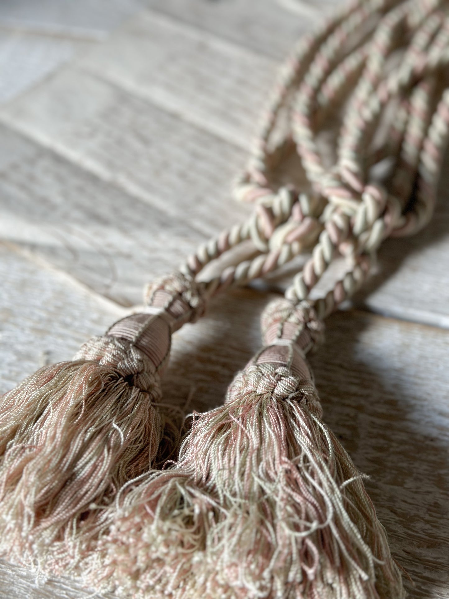 A pair of pretty vintage pastel pink, sage green and ivory curtain tie backs