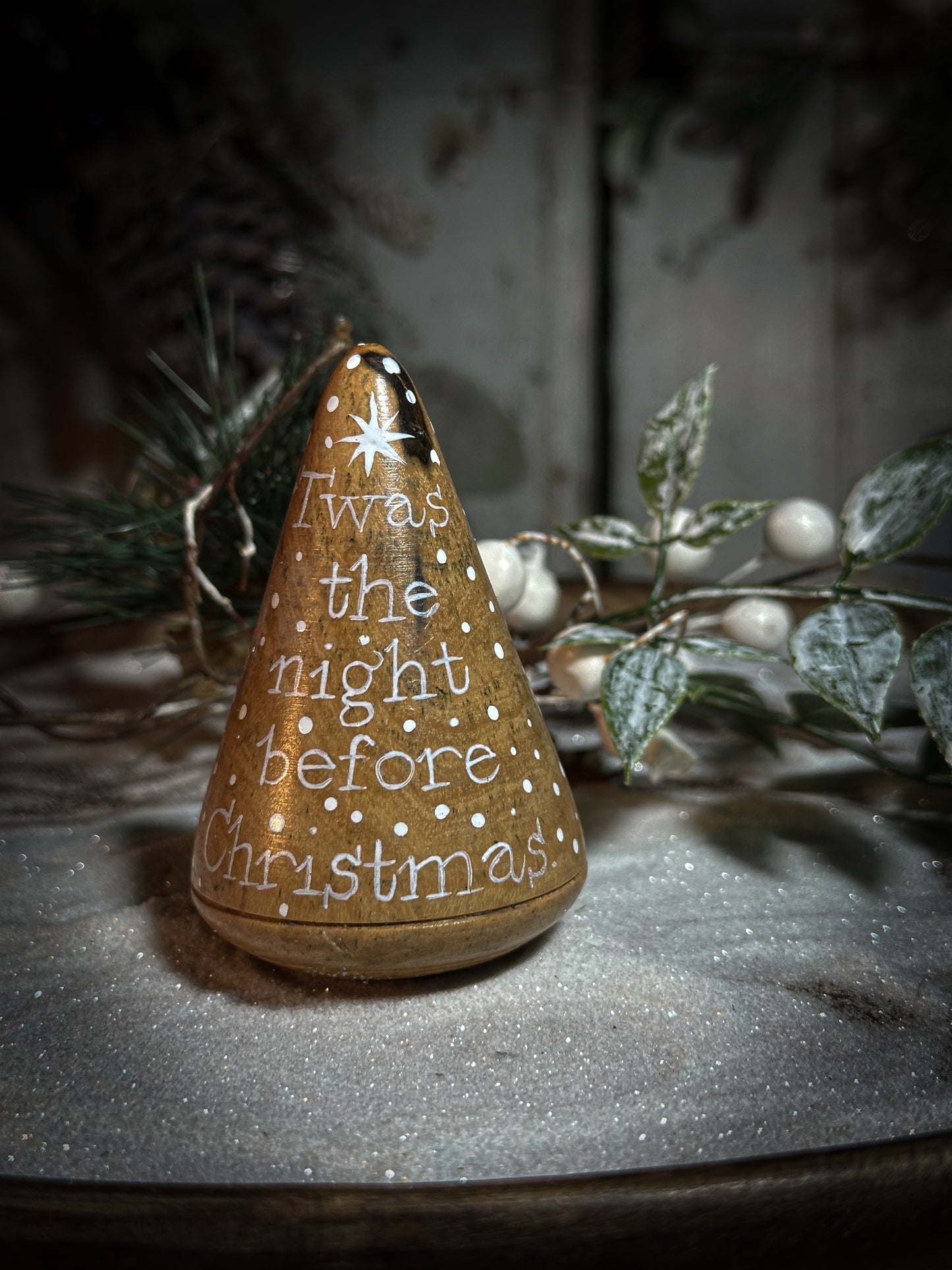 A hand painted quote on a lignum vitae wood plumber’s turnpin with a Christmas quote