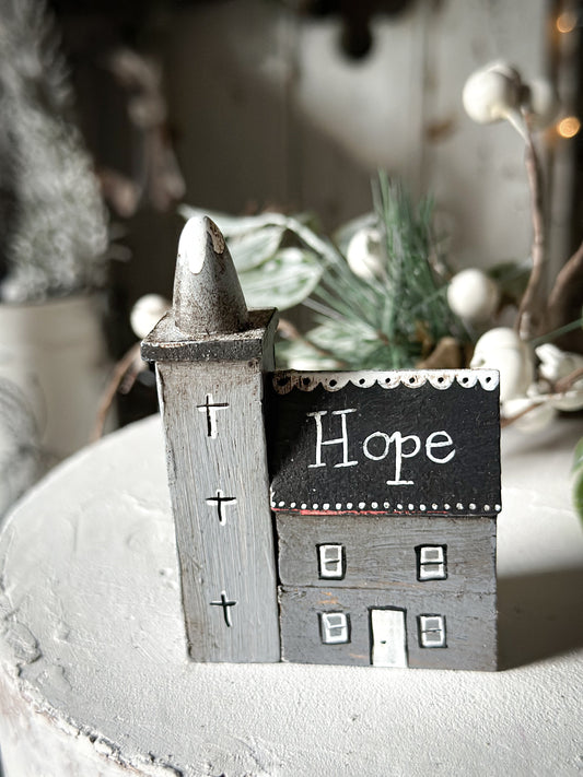 A pretty vintage German Erzgebirge Putz wooden village house painted with a Christmas quote