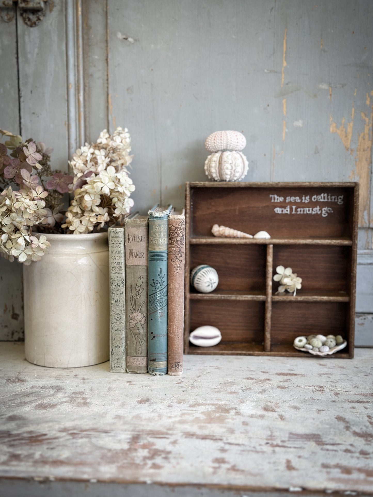 A Vintage Wooden Display Shelf With Hand Painted Quote