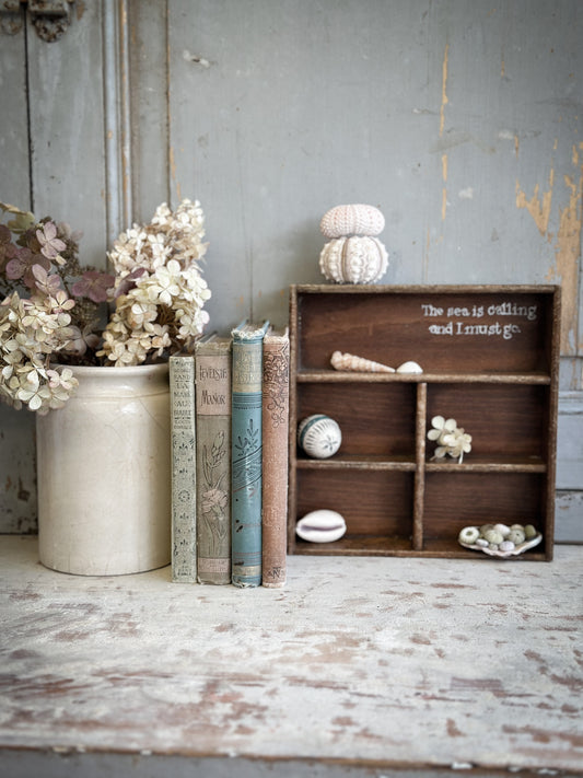 A Vintage Wooden Display Shelf With Hand Painted Quote