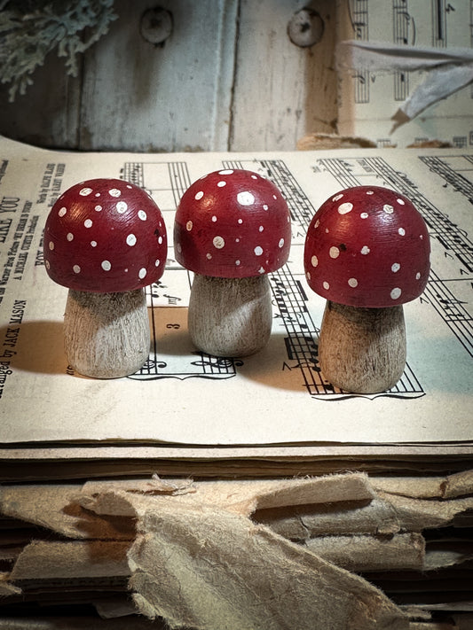 A wooden hand painted Christmas village toadstool