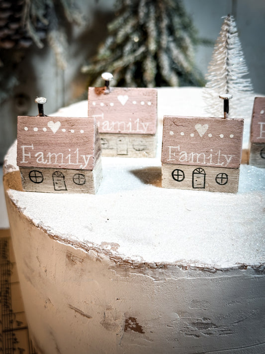 A pretty vintage German Erzgebirge Putz wooden village house painted with a Christmas quote