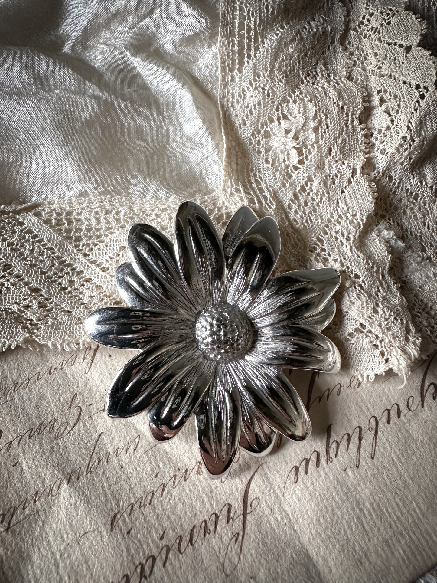 A striking vintage white metal flower brooch