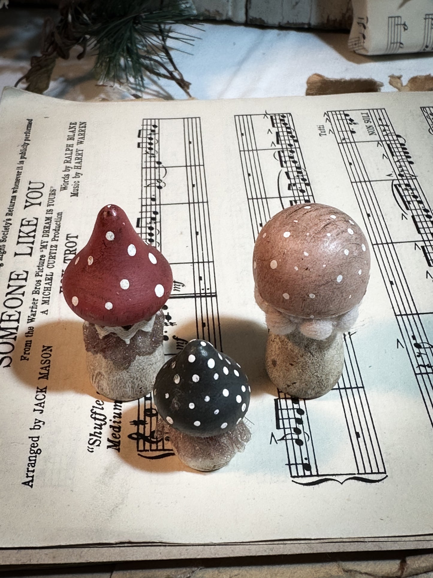 A set of three wooden hand painted and trimmed Christmas village toadstools