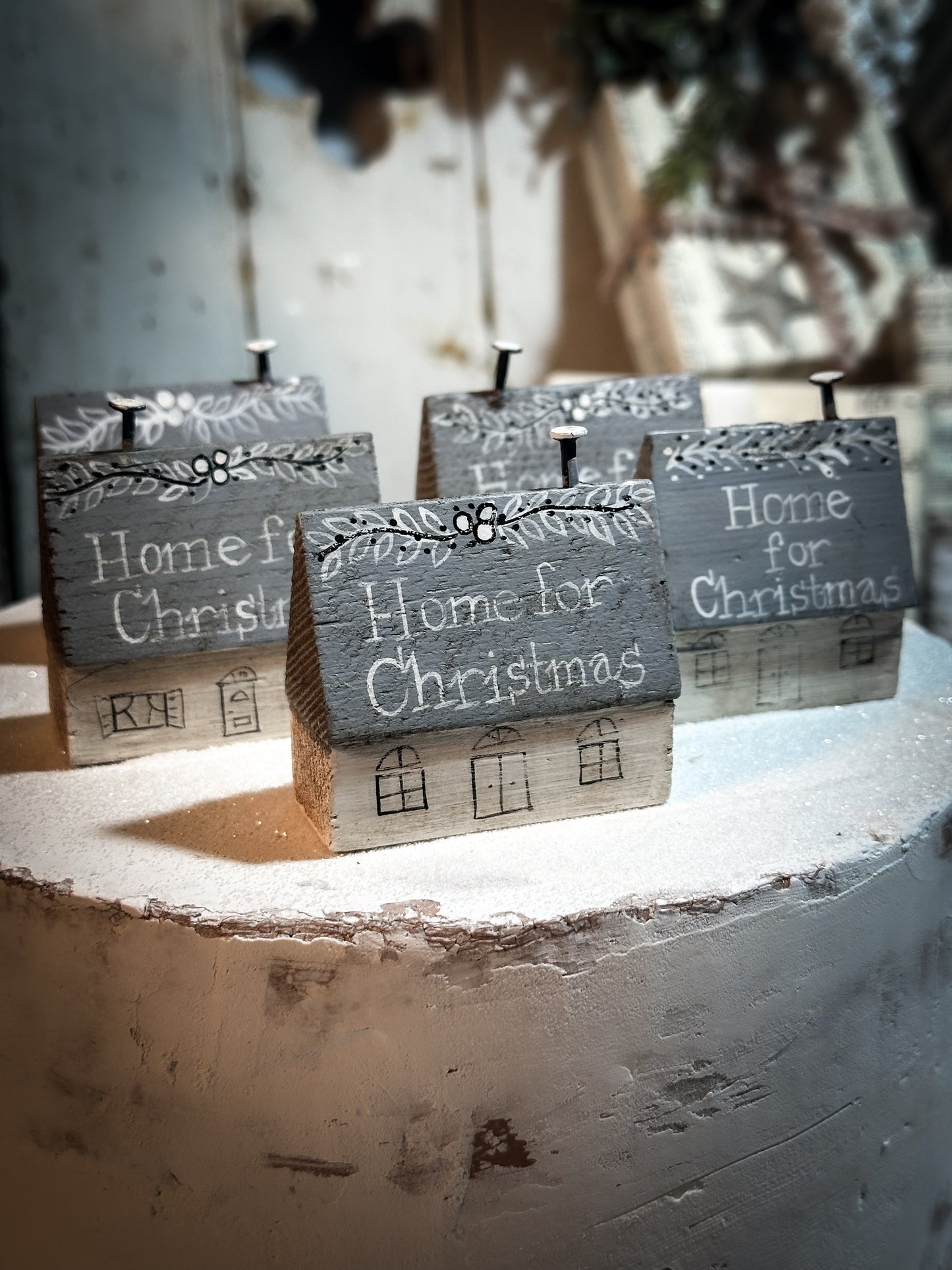 A pretty vintage German Erzgebirge Putz wooden village house painted with a Christmas quote