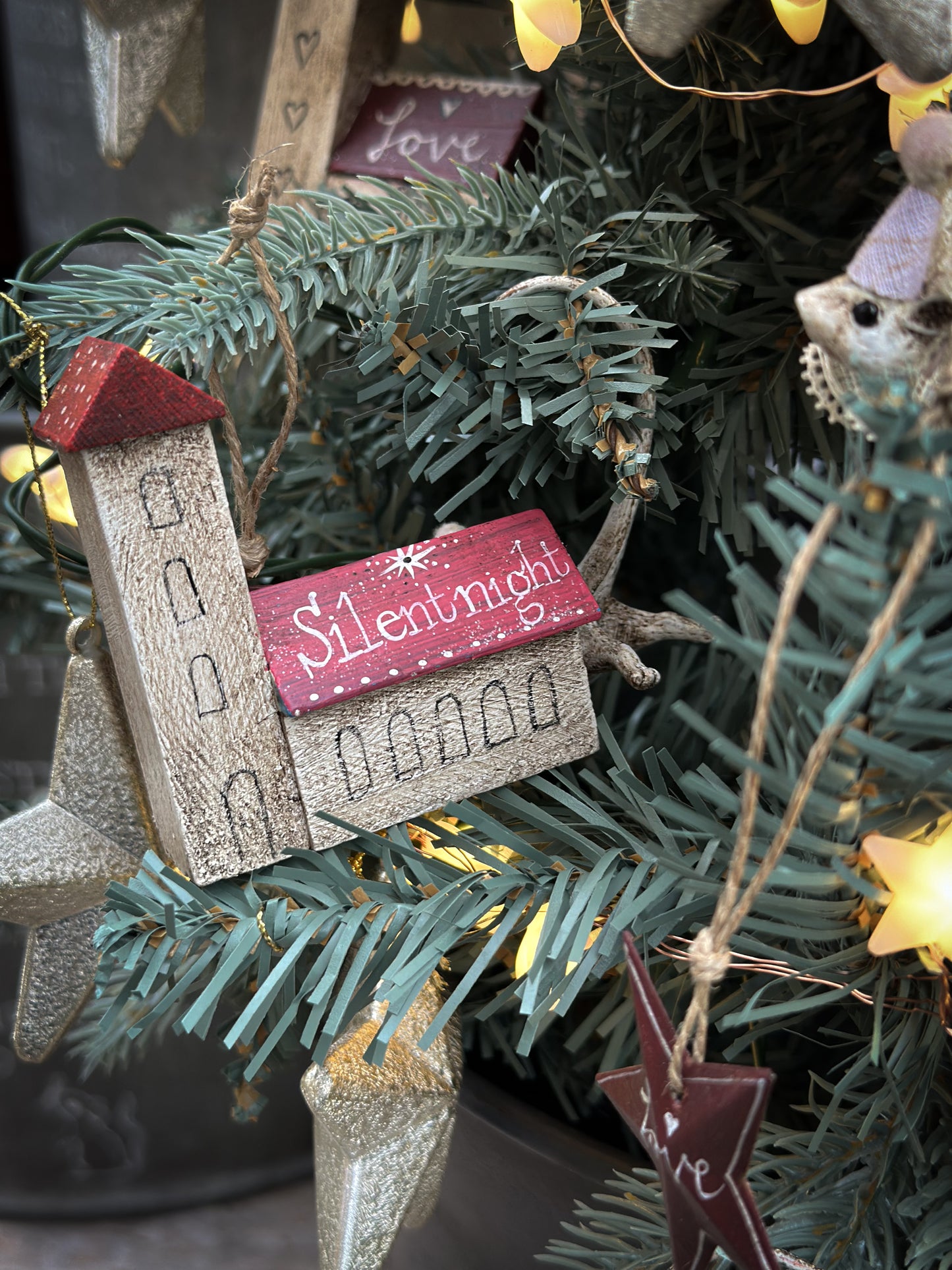 A pretty vintage German Erzgebirge Putz wooden village house painted with a Christmas quote