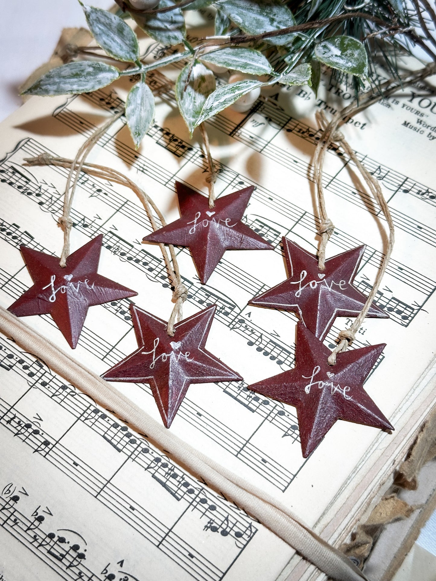 A mini tin barn star red decoration hand painted with “Love”