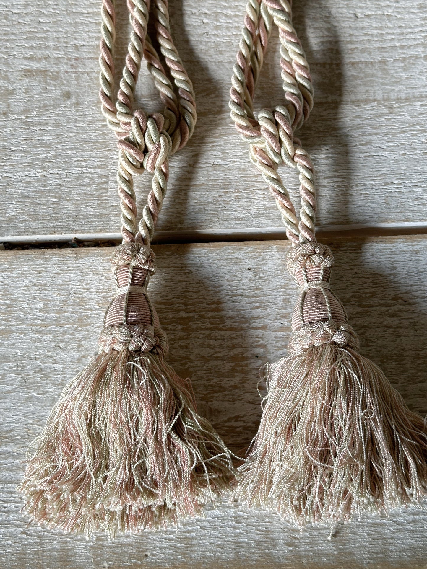 A pair of pretty vintage pastel pink, sage green and ivory curtain tie backs