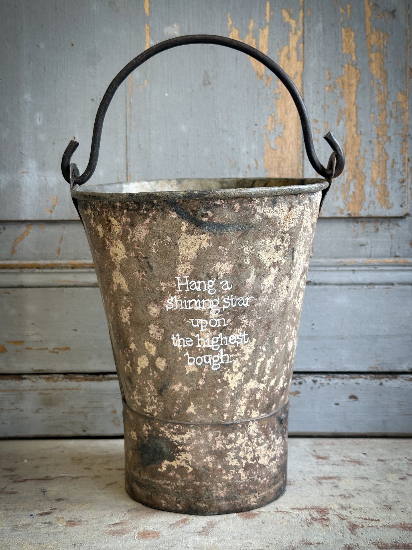 A Recycled Metal Mini Christmas Tree Bucket With A Hand Painted Quote