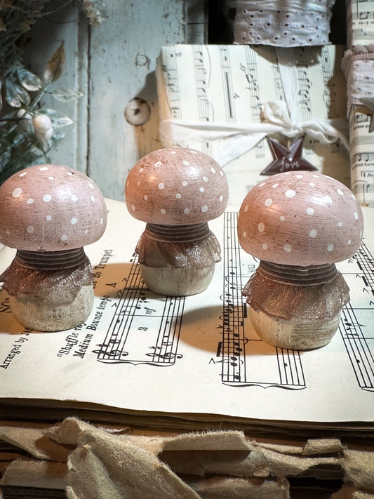 A wooden hand painted and trimmed Christmas village toadstool