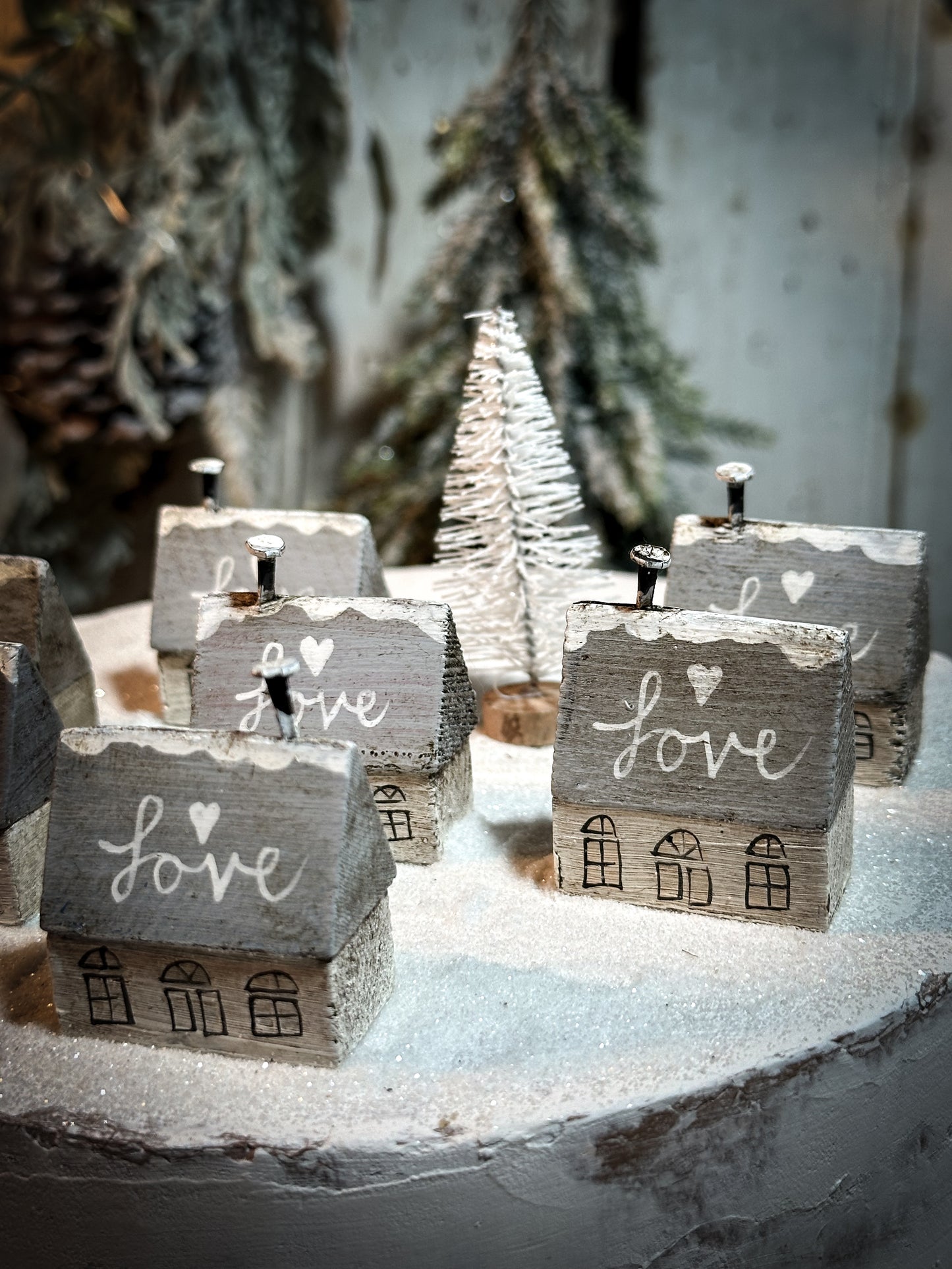 A pretty vintage German Erzgebirge Putz wooden village house painted with a Christmas quote