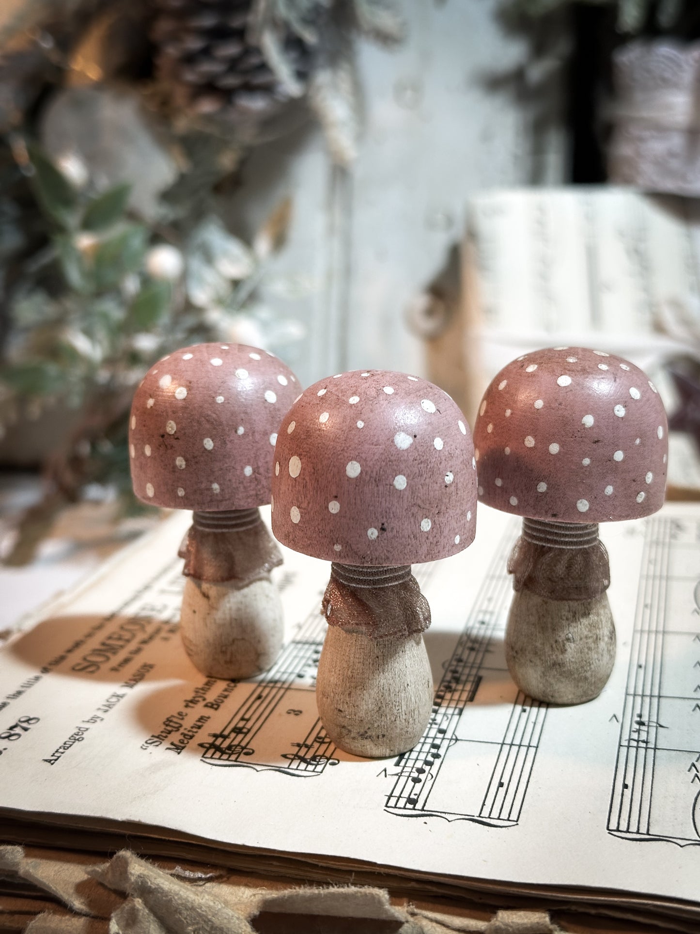 A wooden hand painted and trimmed Christmas village toadstool