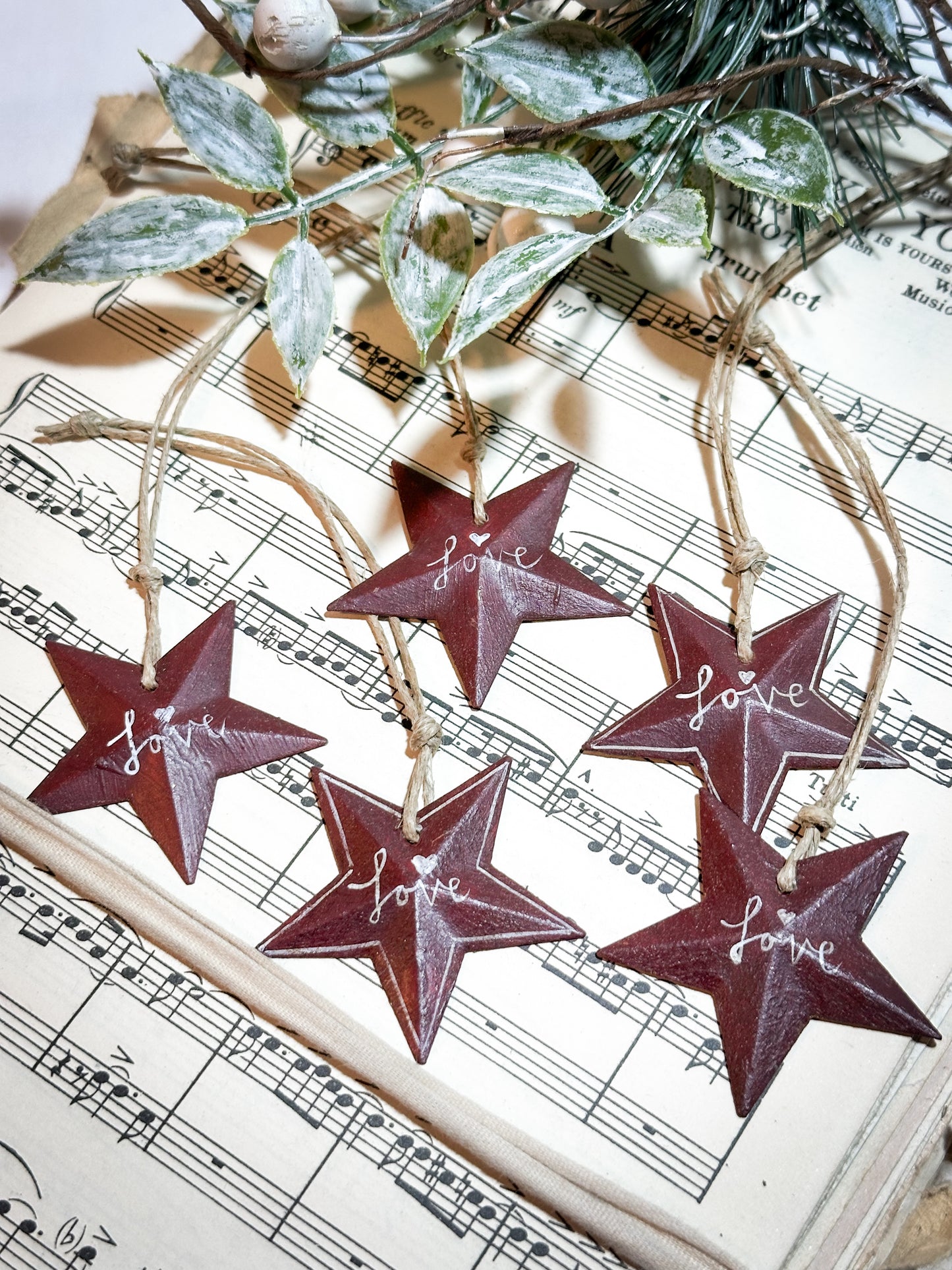 A mini tin barn star red decoration hand painted with “Love”