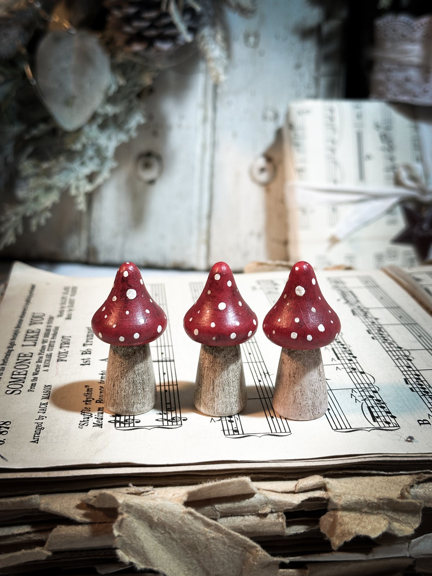 A wooden hand painted Christmas village toadstool