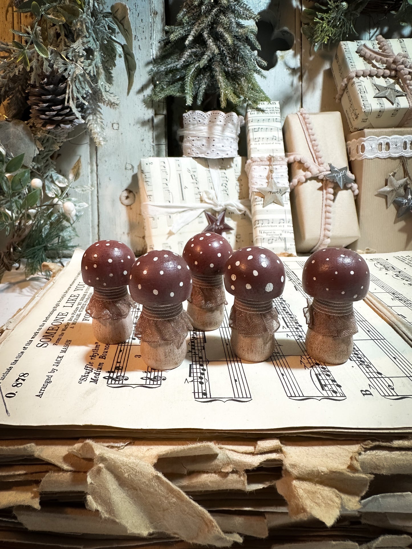 A wooden hand painted and trimmed Christmas village toadstool