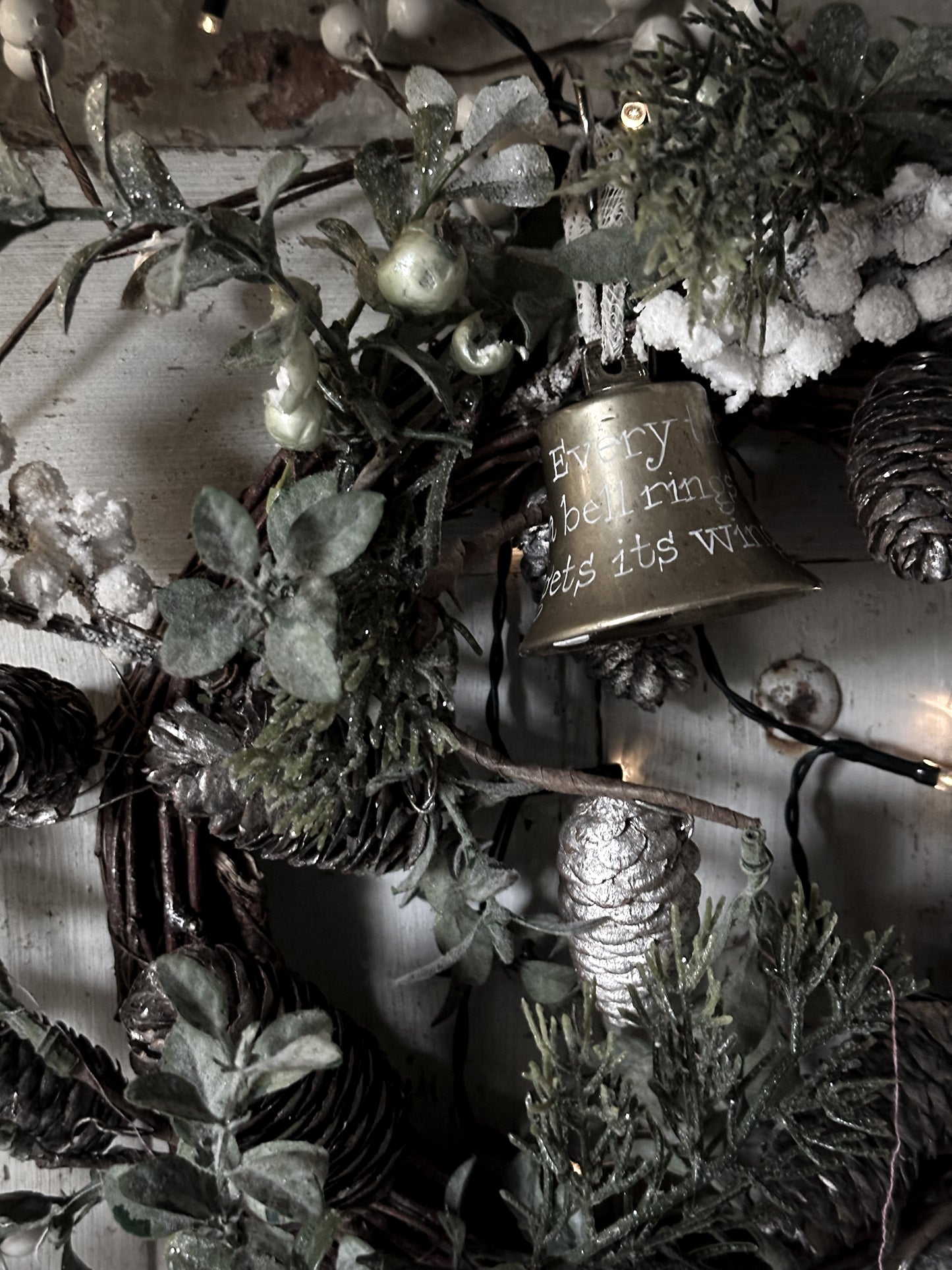 A vintage brass bell with a hand painted quote