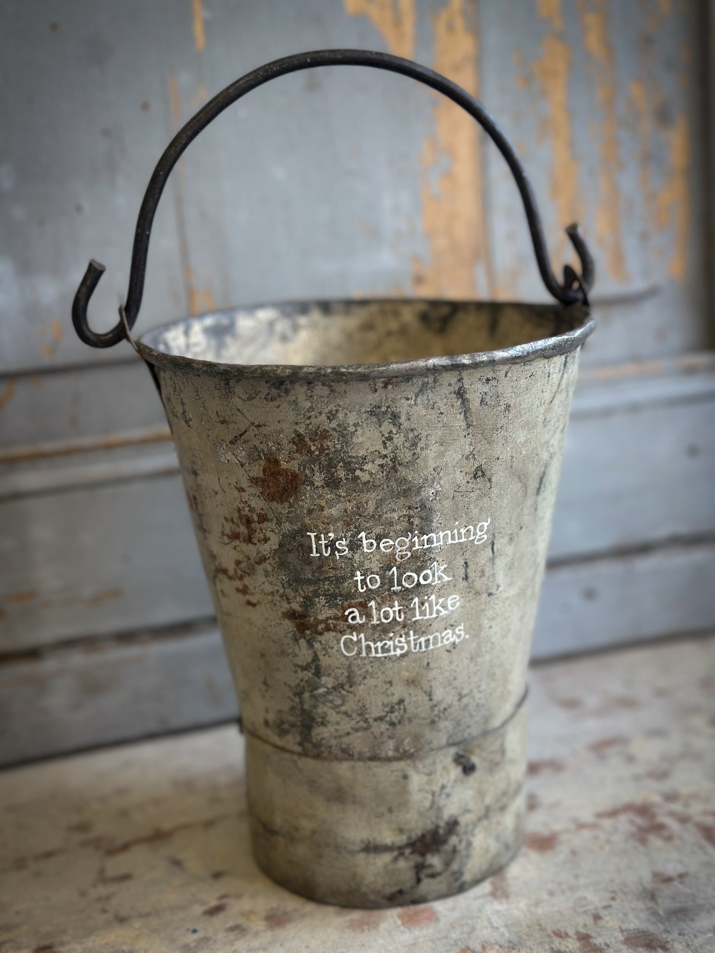 A Recycled Metal Mini Christmas Tree Bucket With A Hand Painted Quote