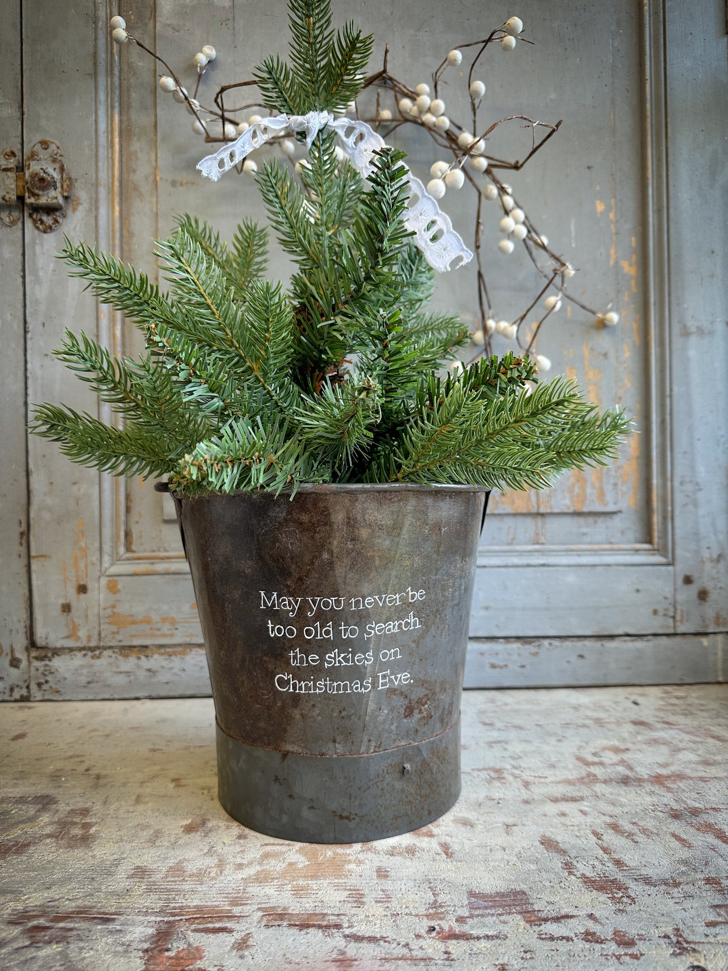 A Recycled Metal Small Christmas Tree Bucket With A Hand Painted Quote