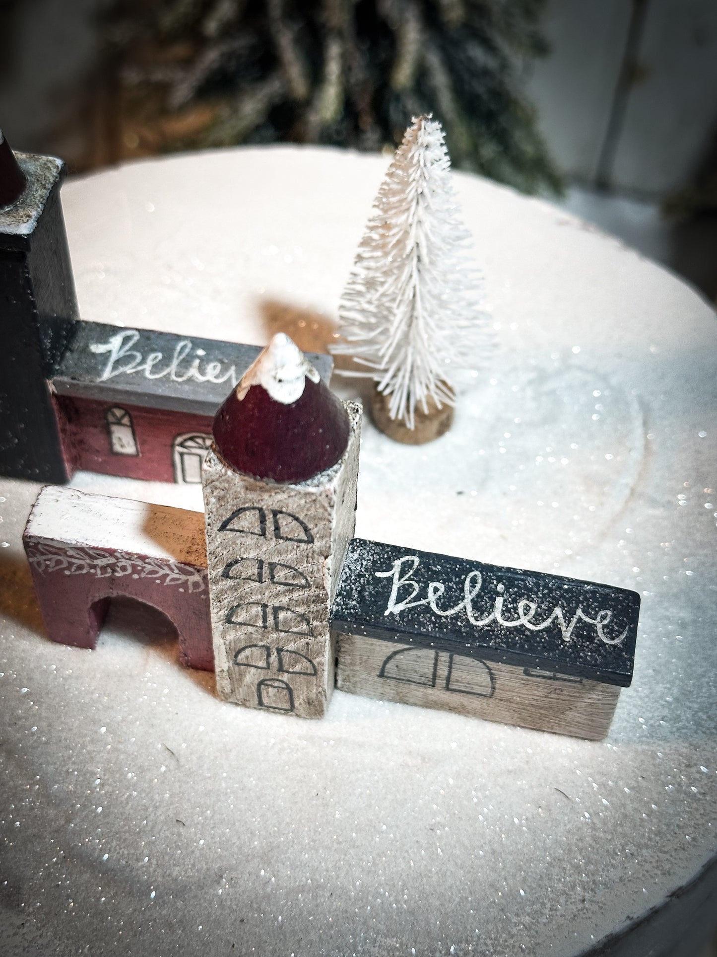 A pretty vintage German Erzgebirge Putz wooden village house painted with a Christmas quote