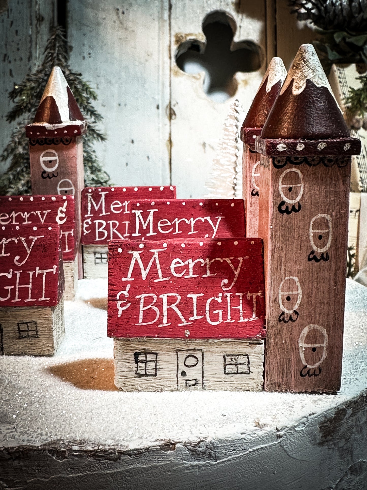 A pretty vintage German Erzgebirge Putz wooden village house painted with a Christmas quote