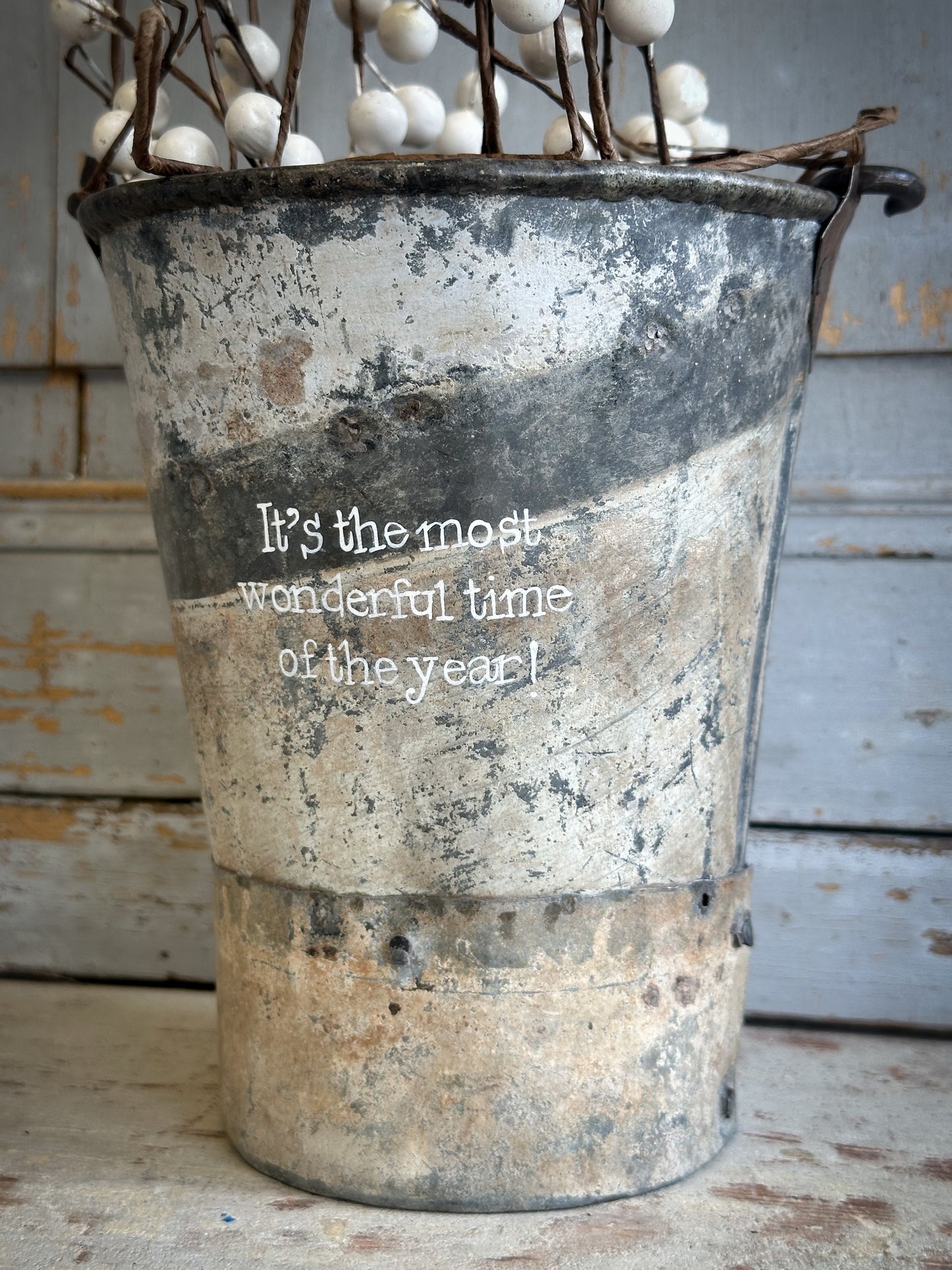 A Recycled Metal Mini Christmas Tree Bucket With A Hand Painted Quote