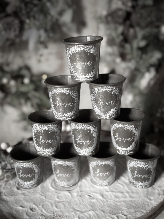 A pretty hand painted Dariole tin tea light holder