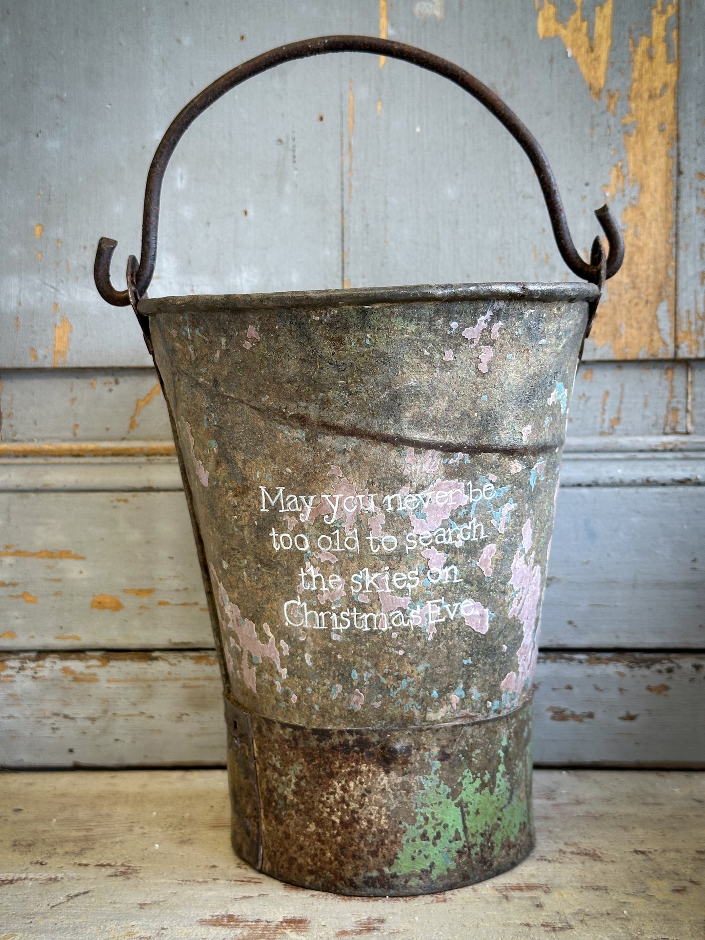A Recycled Metal Mini Christmas Tree Bucket With A Hand Painted Quote
