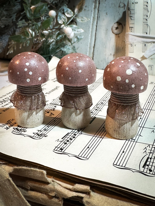 A wooden hand painted and trimmed Christmas village toadstool