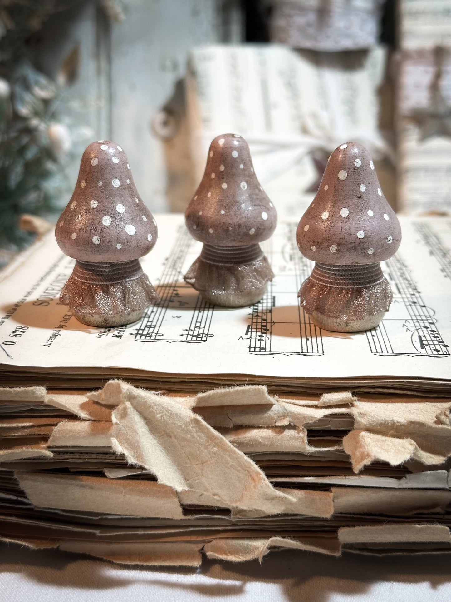 A wooden hand painted and trimmed Christmas village toadstool