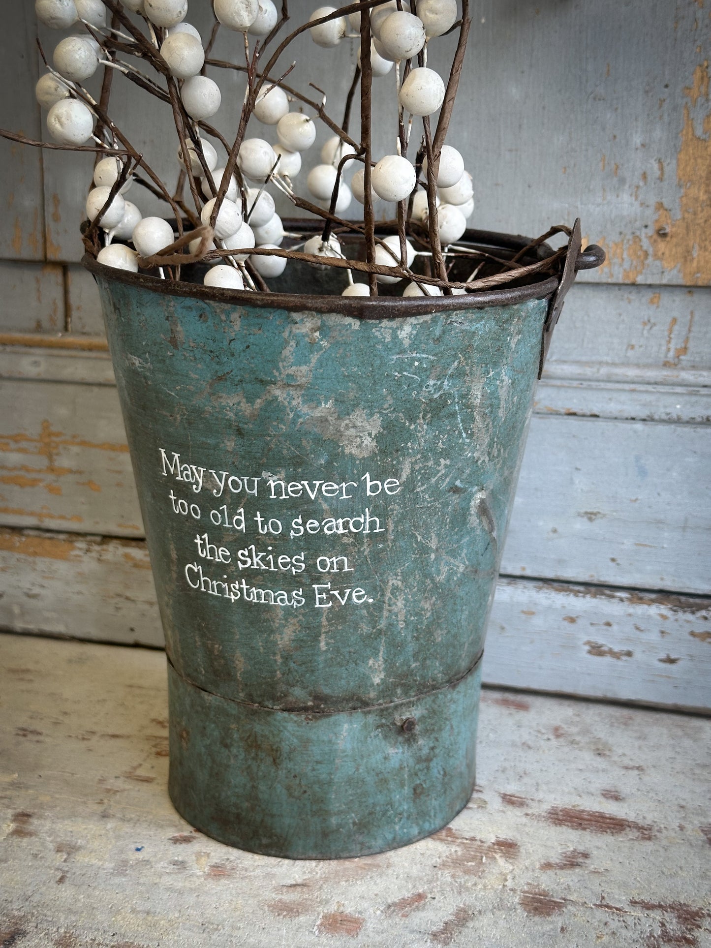 A Recycled Metal Mini Christmas Tree Bucket With A Hand Painted Quote