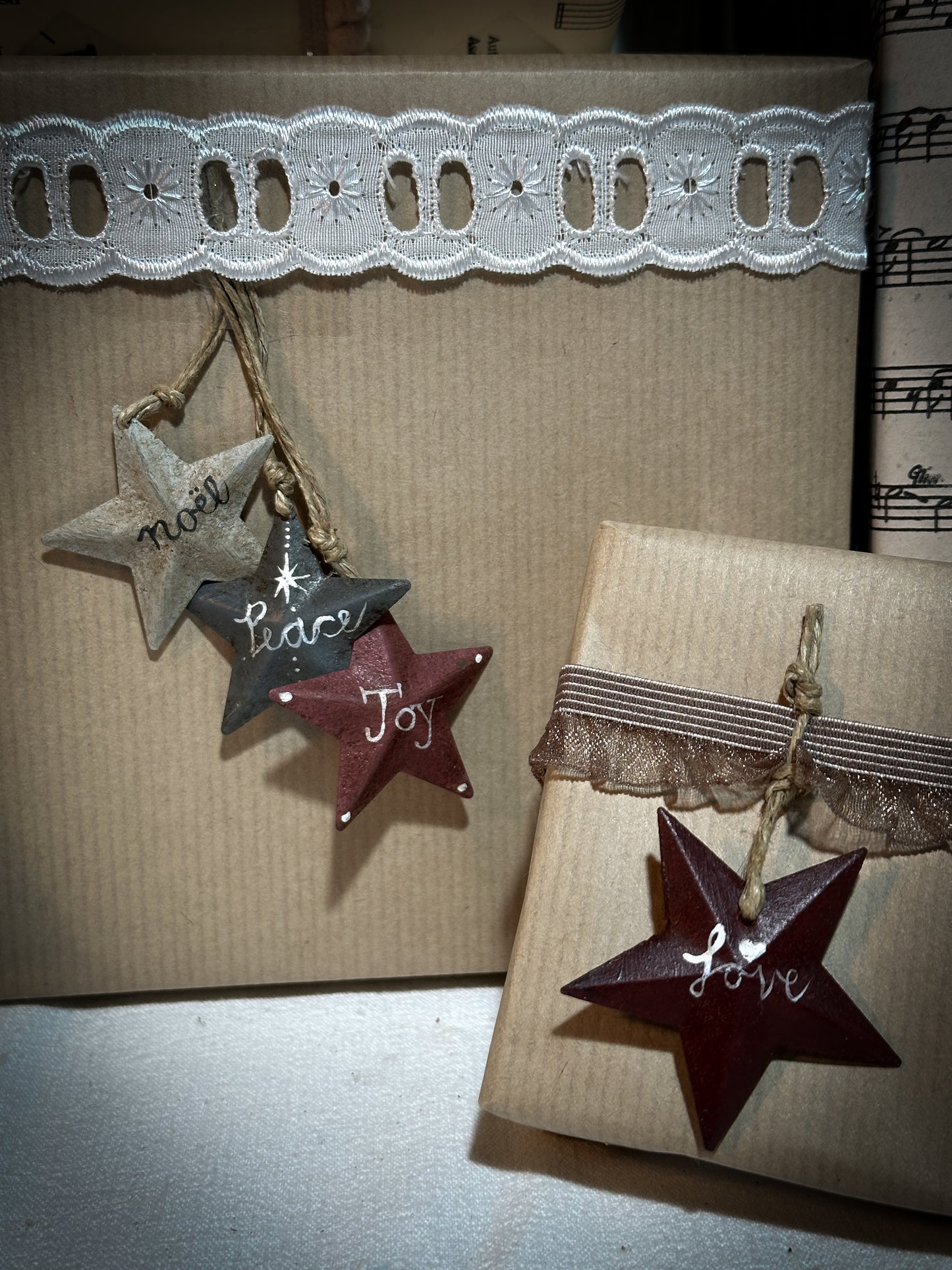 A mini tin barn star pink decoration hand painted with “Joy”