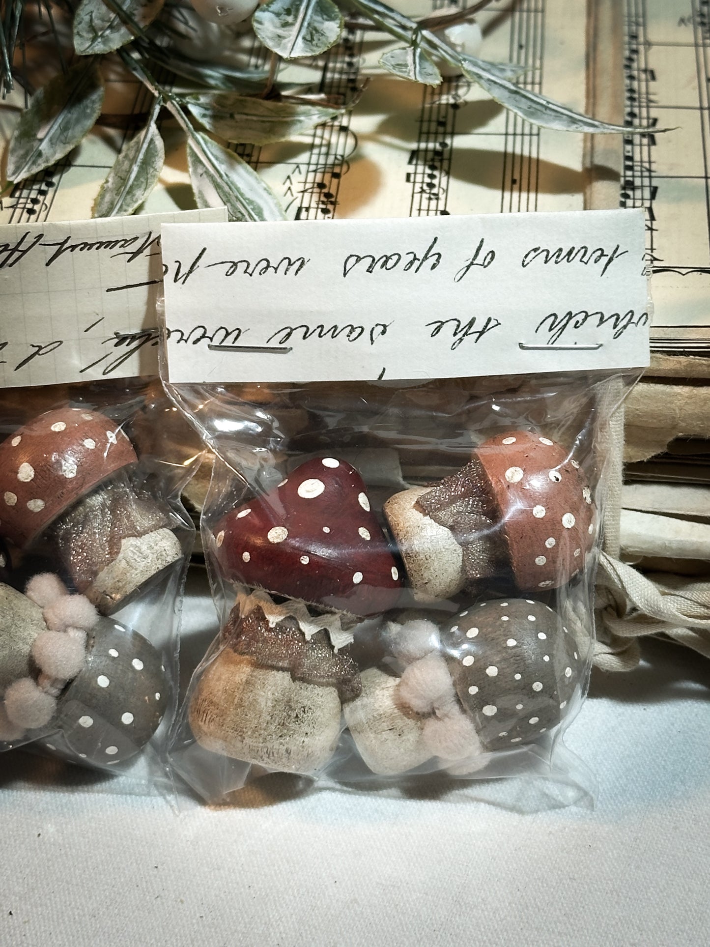 A set of three wooden hand painted and trimmed Christmas village toadstools