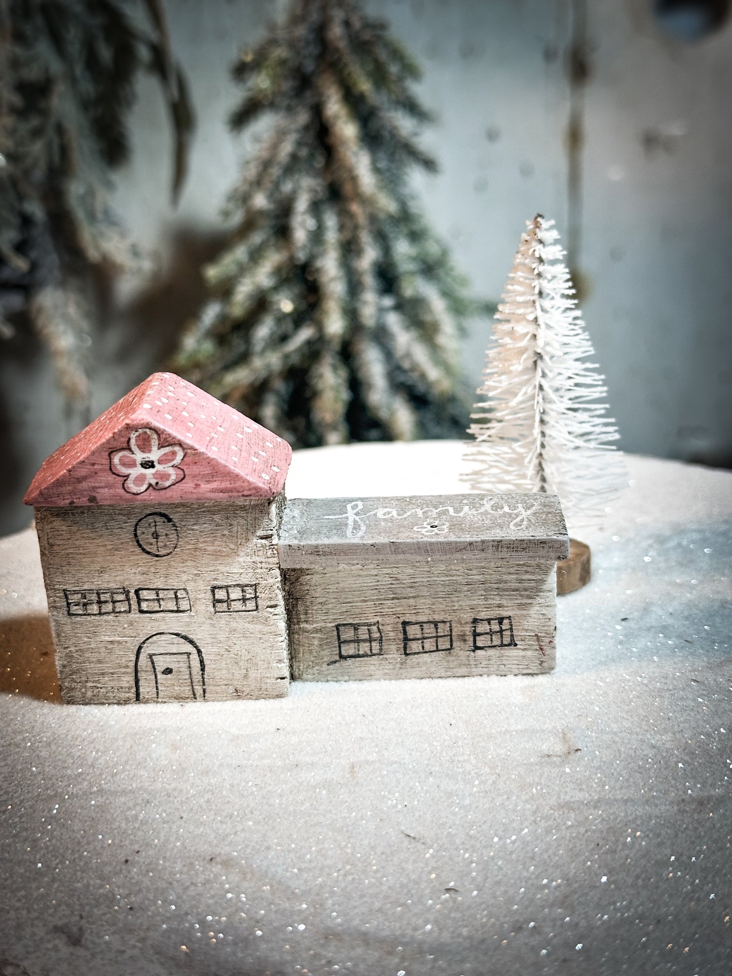 A pretty vintage German Erzgebirge Putz wooden village house painted with a Christmas quote