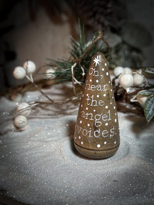 A hand painted quote on a lignum vitae wood plumber’s turnpin with a Christmas quote